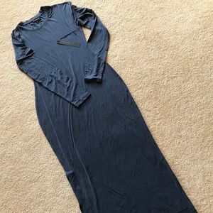 Long-sleeved, full-length, close-fitting dress.